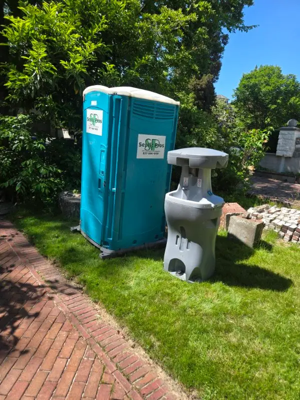 A Septic Pros portable toilet paired with a freestanding handwashing station