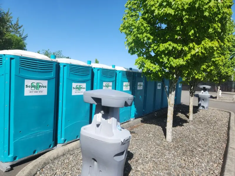 A row of Septic Pros portable toilets placed for a long-term job-site rental